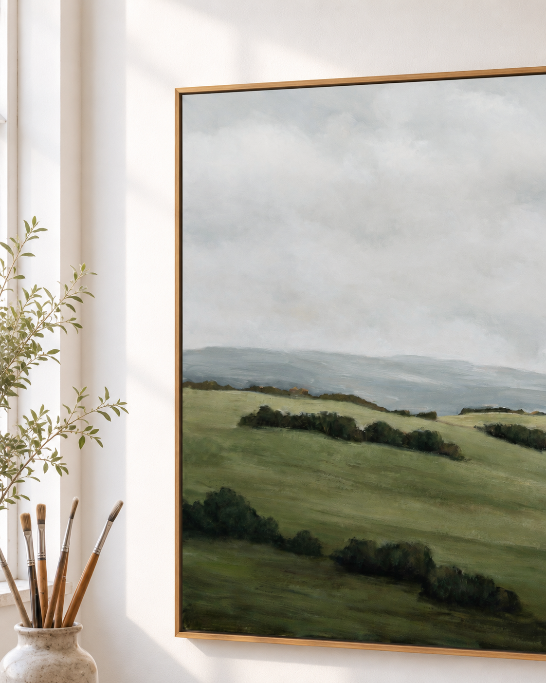 Calm After the Rain by Jeannie — an original Australian landscape painting of green rolling hills under a soft sky, framed in natural oak timber.